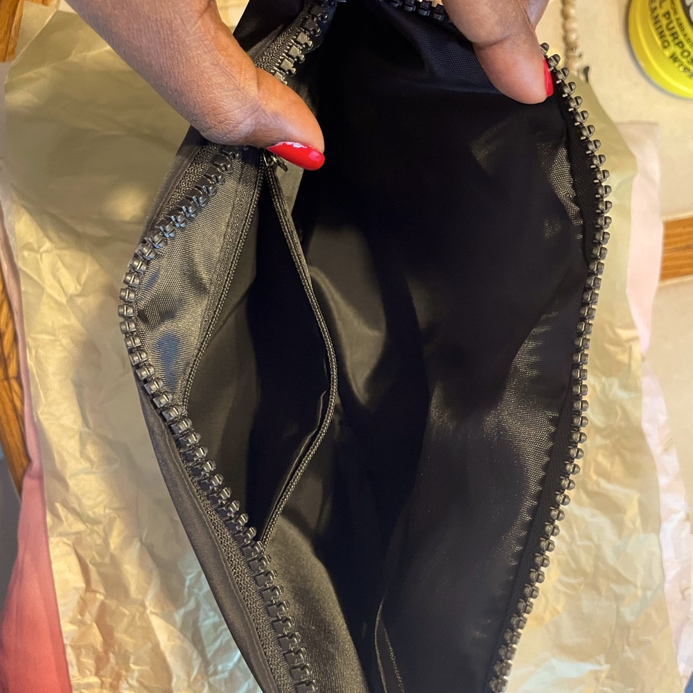 Brand new black Chanel cosmetic pouch, never worn.